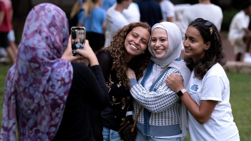 Three students pose for a photo at FallFest