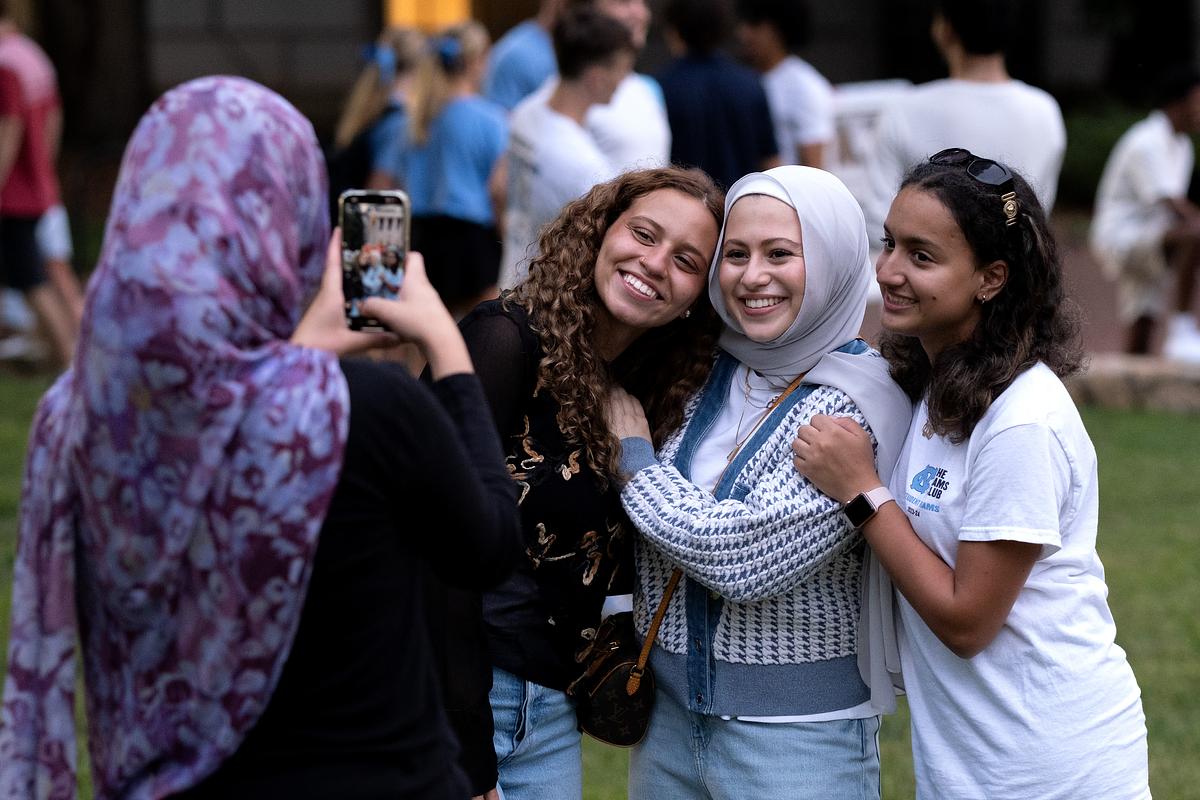 Three students pose for a photo at FallFest