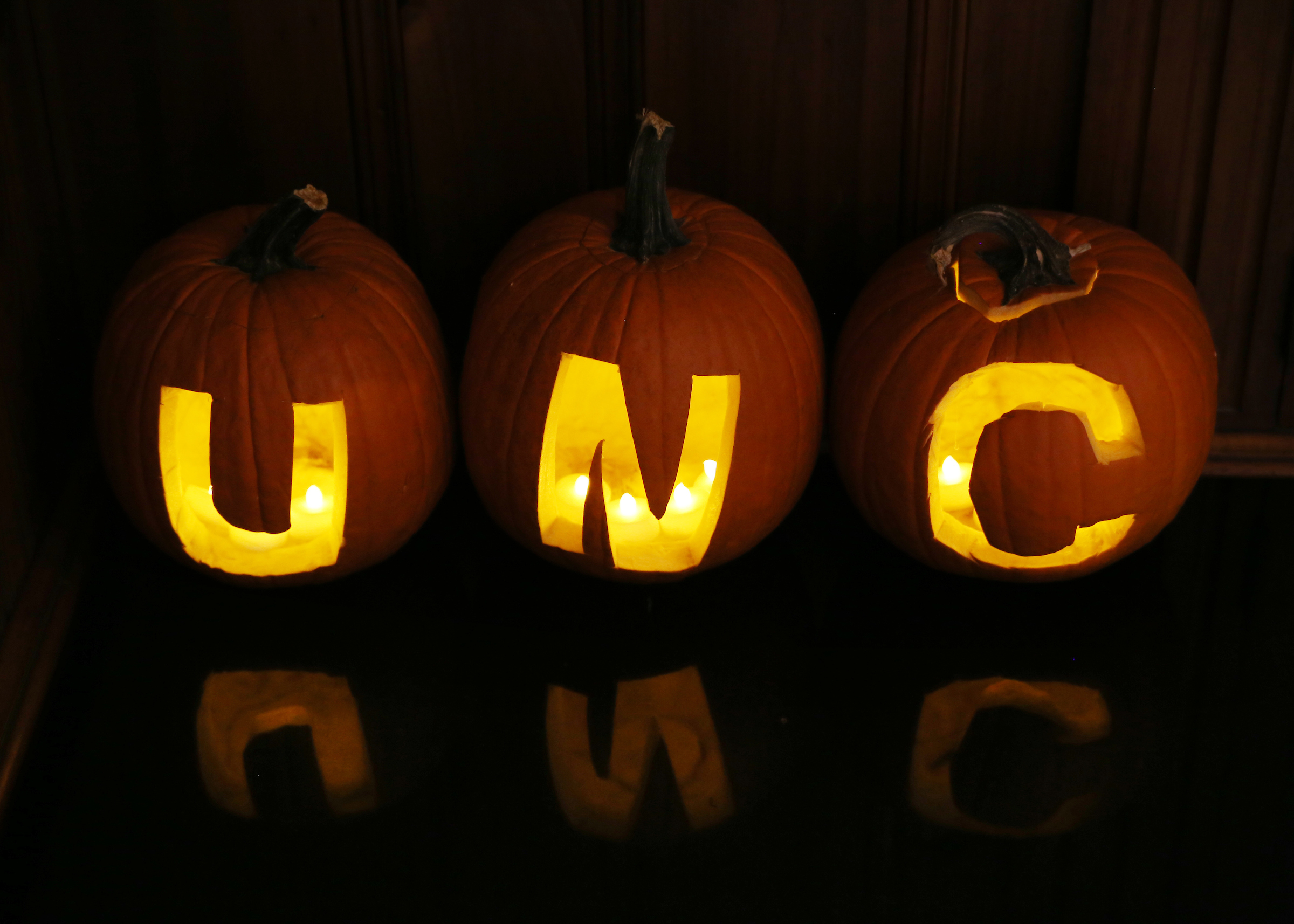 Carved pumpkins that read U-N-C