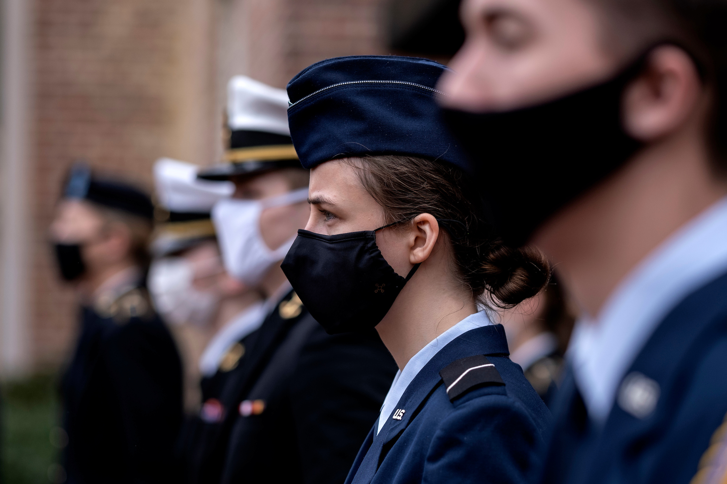 Students wearing military regalia and a mask