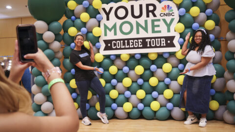 Students stand in front of a balloon wall for the CNBC Your Money Event