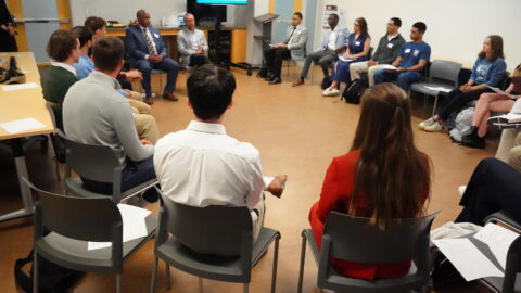 A group of people sitting in a circle in discussion