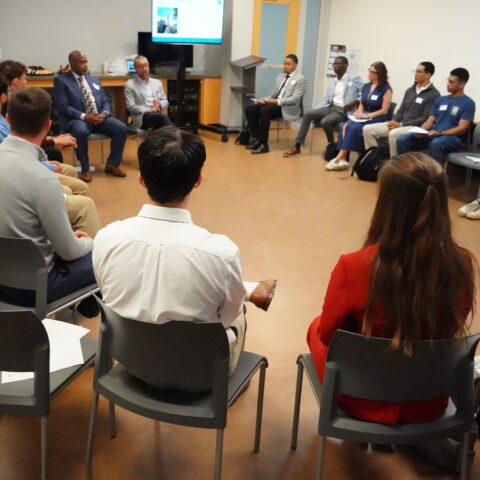 A group of people sitting in a circle in discussion