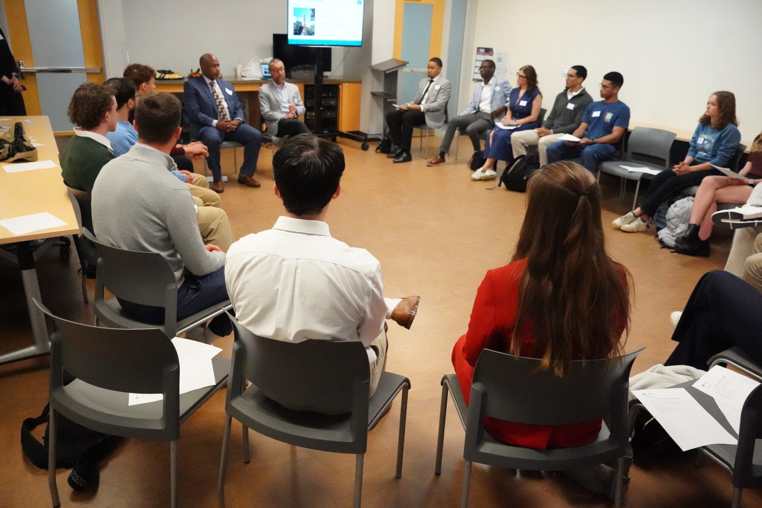 A group of people sitting in a circle in discussion